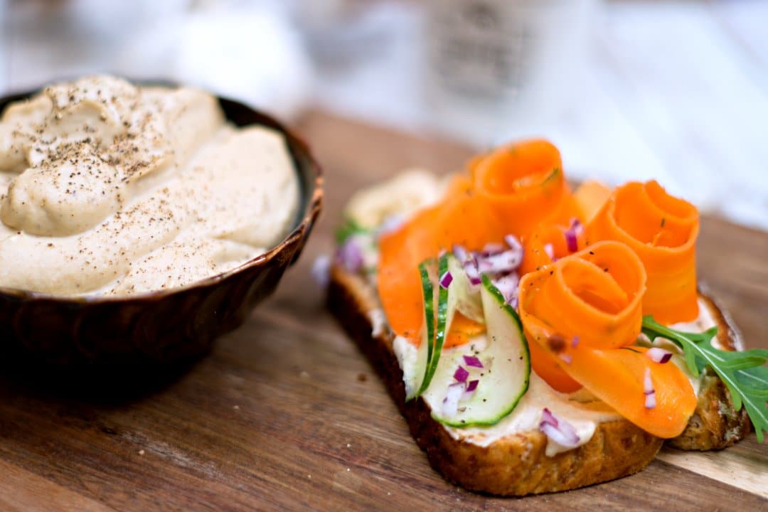 Toast with cashew mayo and marinated carrot slices. 