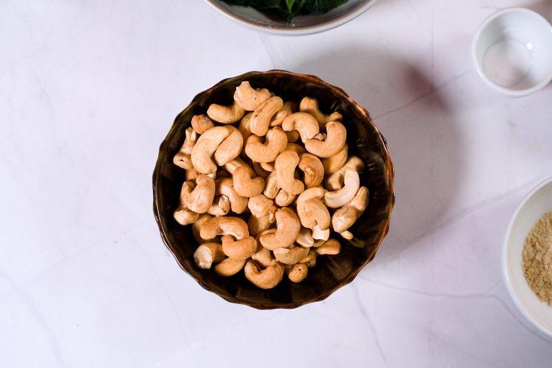 roastec cashews in brown bowl on white surface