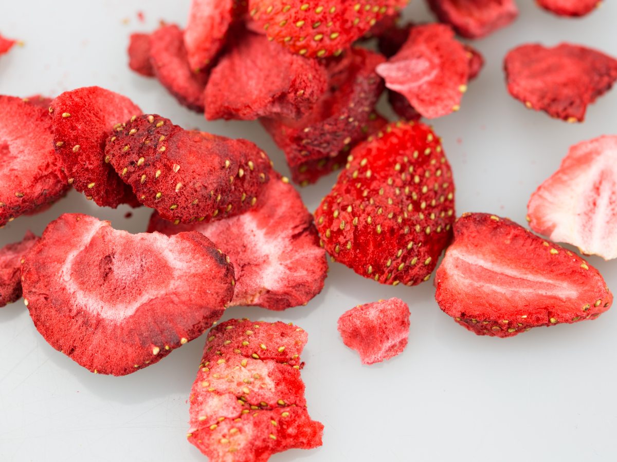 Freeze dried strawberries on white surface. 